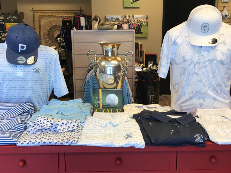 Golf Pro Shop at Pheasant Run Golf Club featuring a table of men's apparel.